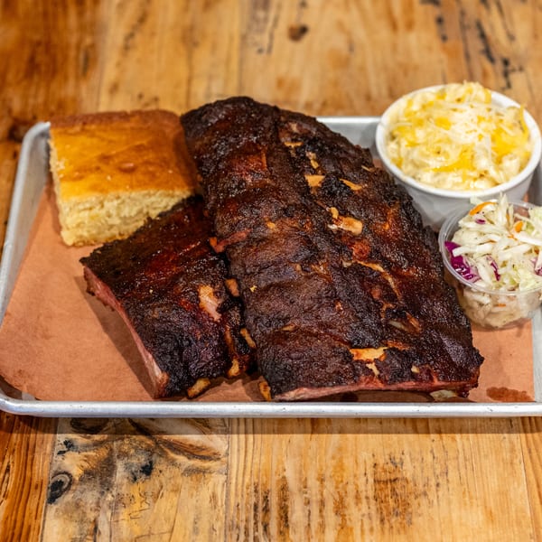 David Alan Alan's Smokehouse & Saloon's BBQ ribs, cornbread, mac and cheese, and coleslaw.