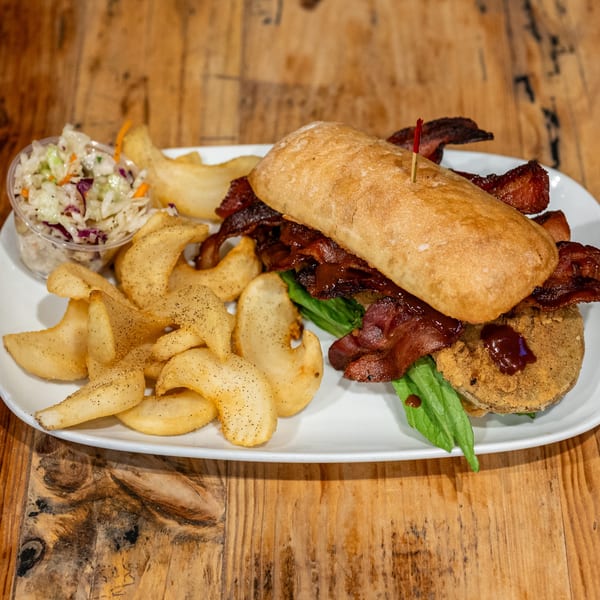 BBQ sandwich with bacon, fried green tomato, lettuce, served with seasoned fries and coleslaw.